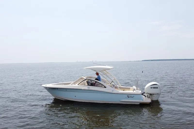 Slide: The Image of 2022 Scout 240 Dorado boat on calm water with Yamaha engine. - 3