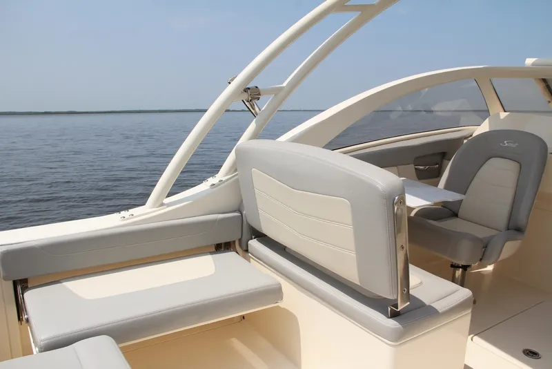 Slide: The Image of 2022 Scout 240 Dorado boat interior with sleek seating and ocean view. - 11