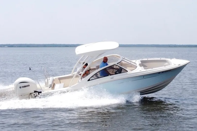 Slide: The Image of 2022 Scout 240 Dorado boat cruising on water with Yamaha engine. - 6