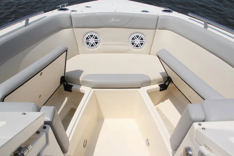 Slide: The Image of 2022 Scout 240 Dorado boat interior with cushioned seating and storage compartments. - 15