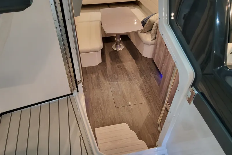Slide: The Image of Interior view of 2027 Formula 430 Super Sport Crossover, featuring elegant seating and table. - 25