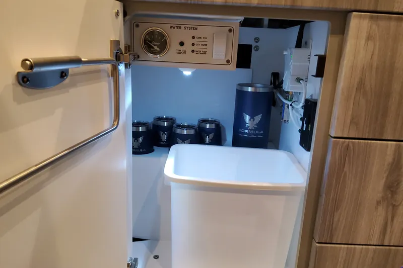 Slide: The Image of Interior view of Formula 430 Super Sport Crossover 2027, featuring water system and branded containers. - 28