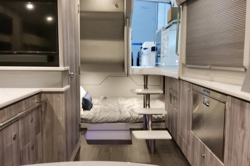 Slide: The Image of Interior of 2027 Formula 430 Super Sport Crossover, featuring modern design and cozy sleeping area. - 32