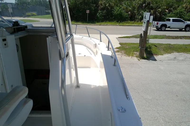 Slide: The Image of 2004 Stamas 310 Tarpon boat docked, showing deck and interior cabin entrance. - 22