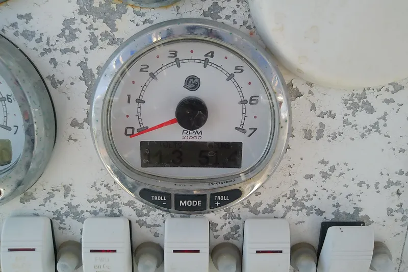 Slide: The Image of Close-up of a 2004 Stamas 310 Tarpon boat tachometer displaying RPM and controls. - 44