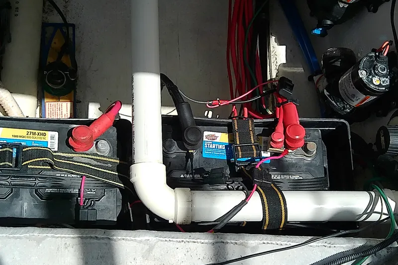 Slide: The Image of Battery compartment of a 2004 Stamas 310 Tarpon boat with wiring and connectors. - 54