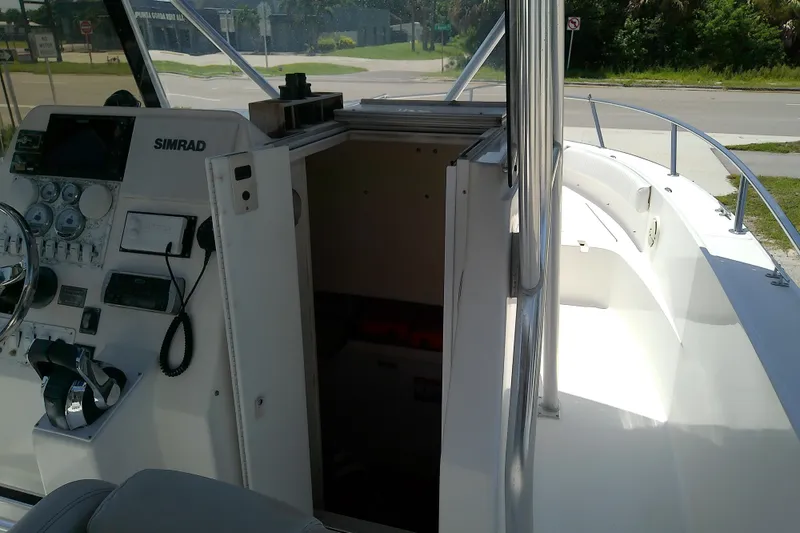 Slide: The Image of 2004 Stamas 310 Tarpon boat interior with control panel and open cabin door. - 20