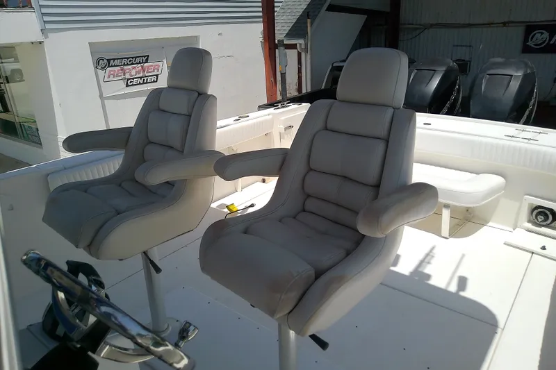 Slide: The Image of 2004 Stamas 310 Tarpon boat interior with two cushioned captain's chairs at Mercury Repower Center. - 36