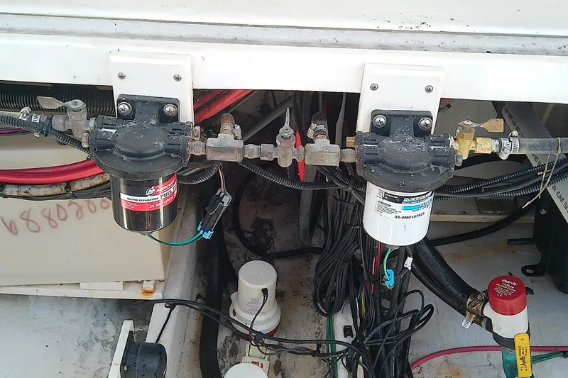 Slide: The Image of 2004 Stamas 310 Tarpon boat engine compartment with fuel filters and wiring. - 57