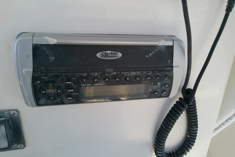 Slide: The Image of Clarion marine stereo system on a 2004 Stamas 310 Tarpon boat dashboard. - 41