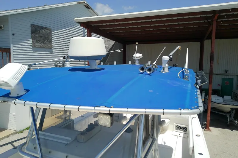 Slide: The Image of 2004 Stamas 310 Tarpon boat with blue canopy and radar equipment. - 32