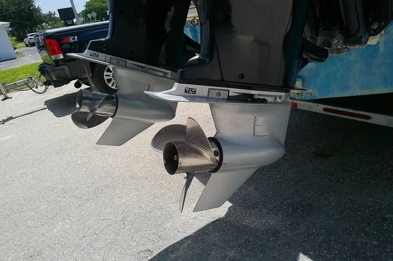 Slide: The Image of Twin outboard motors on a 2004 Stamas 310 Tarpon boat, parked on a trailer. - 14
