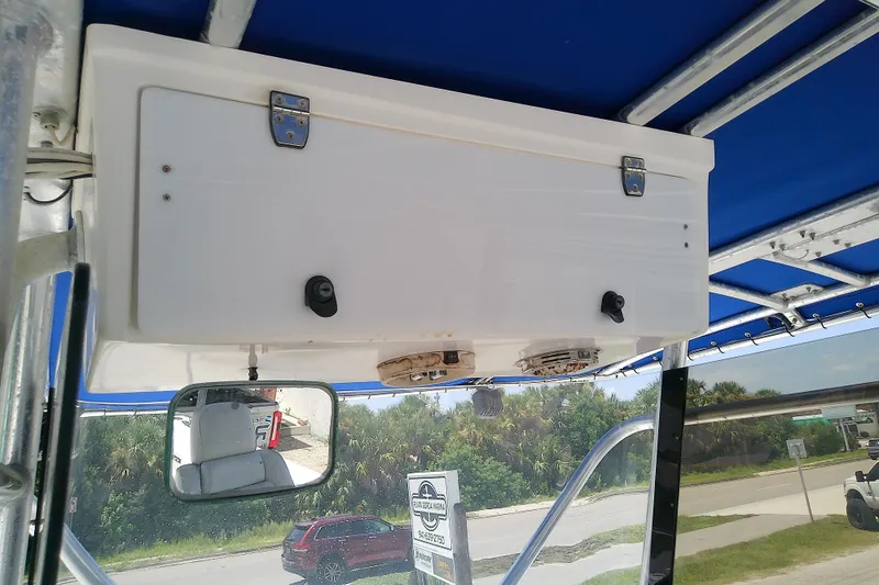 Slide: The Image of 2004 Stamas 310 Tarpon boat console with storage compartment and rearview mirror. - 49