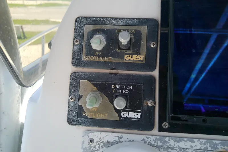 Slide: The Image of Control panel of a 2004 Stamas 310 Tarpon boat with spotlight switches. - 42