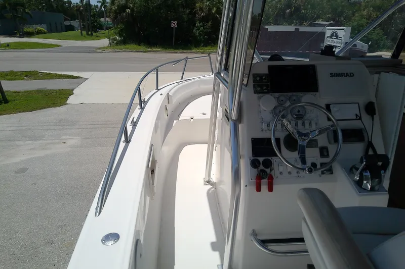 Slide: The Image of 2004 Stamas 310 Tarpon boat interior with steering console and navigation equipment. - 23