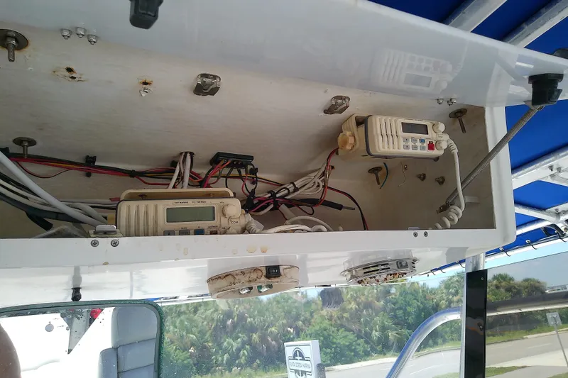 Slide: The Image of 2004 Stamas 310 Tarpon boat electronics compartment with wiring and communication devices. - 50