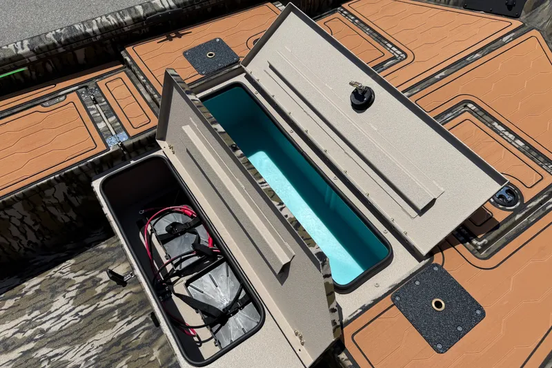 Slide: The Image of Open storage compartments on a 2027 Avid 18 Commander boat, showcasing interior design. - 9