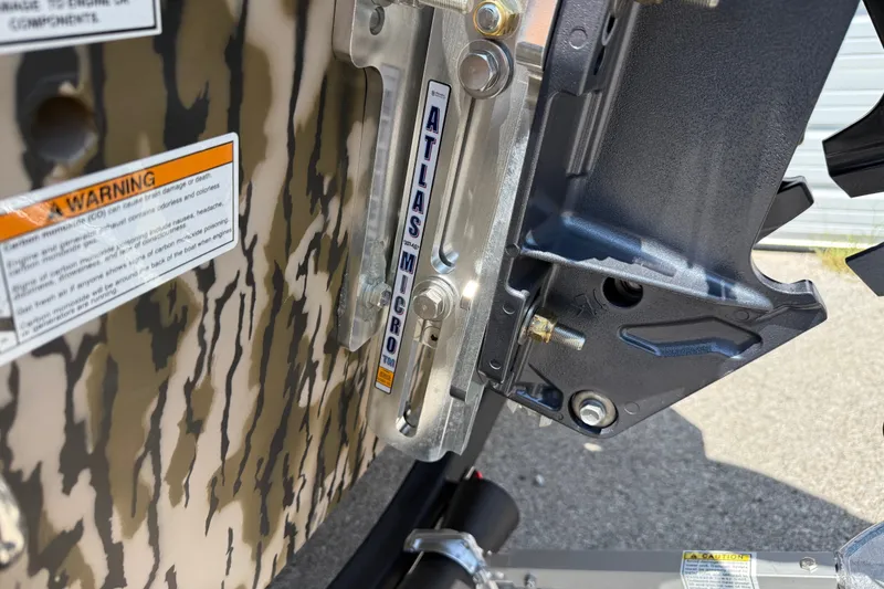 Slide: The Image of Close-up of 2027 Avid 18 Commander boat's Atlas Micro jack plate and warning label. - 3