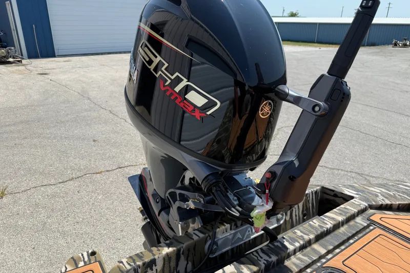 Slide: The Image of 2027 Avid 18 Commander with Yamaha SHO VMAX outboard motor in a parking area. - 12