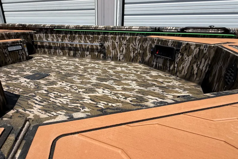 Slide: The Image of 2027 Avid 18 Commander boat interior with camouflage design and orange accents. - 6