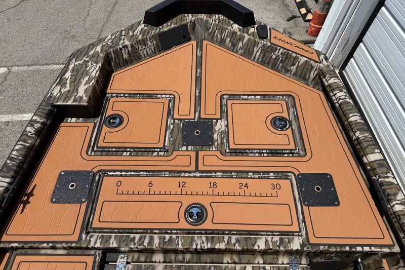 Slide: The Image of 2027 Avid 18 Commander boat deck with camo design and orange padding. - 8