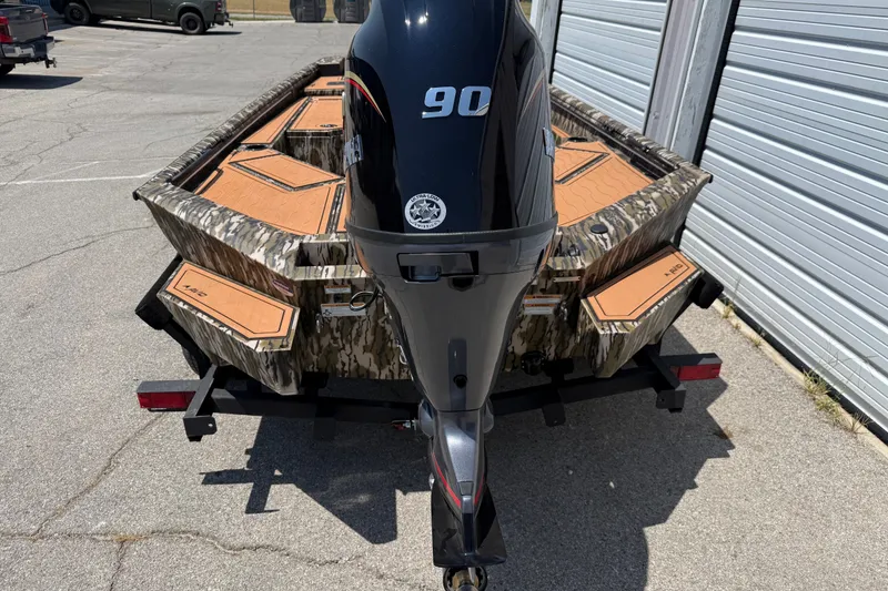 Slide: The Image of 2027 Avid 18 Commander boat with camouflage design and 90 HP outboard motor. - 2