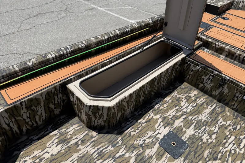 Slide: The Image of 2027 Avid 18 Commander boat interior with open storage compartment and camouflage design. - 10