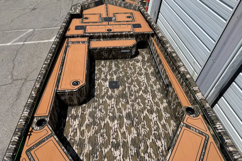 Slide: The Image of 2027 Avid 18 Commander boat interior with camouflage and tan design. - 7