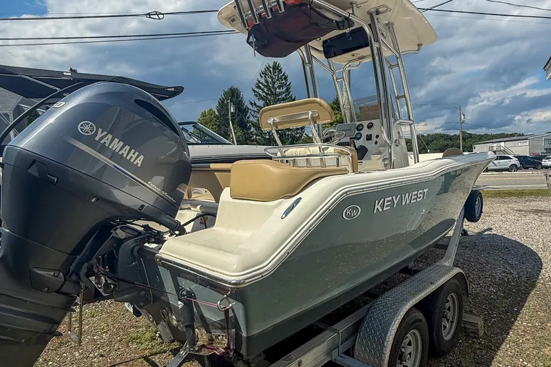 Slide: The Image of 2019 Key West 203 FS boat with Yamaha engine on trailer, outdoor setting. - 14