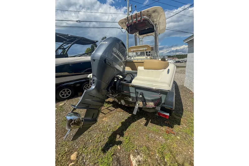 Slide: The Image of 2019 Key West 203 FS boat with Yamaha outboard motor, parked on a trailer. - 13