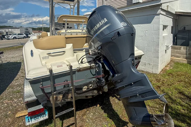 Slide: The Image of 2019 Key West 203 FS boat with Yamaha outboard motor, parked outdoors. - 12