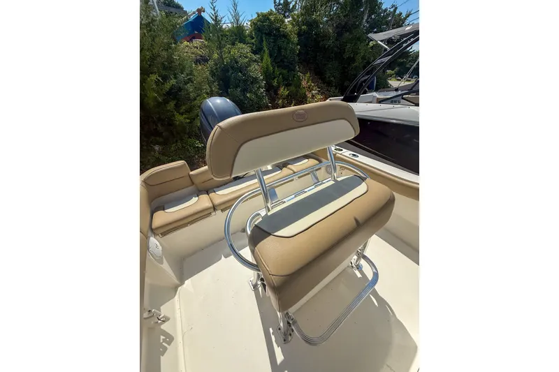 Slide: The Image of 2019 Key West 203 FS boat interior with tan seating and chrome accents. - 6