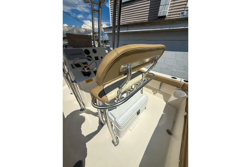 Slide: The Image of 2019 Key West 203 FS boat interior with steering console and cushioned seating. - 10