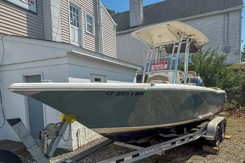 Slide: The Image of 2019 Key West 203 FS boat on trailer, parked beside a building. - 2
