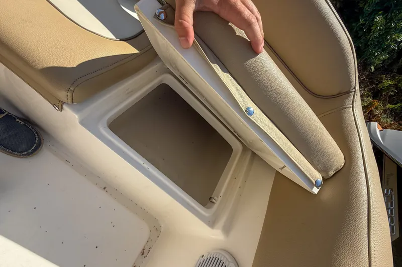 Slide: The Image of 2019 Key West 203 FS boat seat storage compartment with open lid. - 9