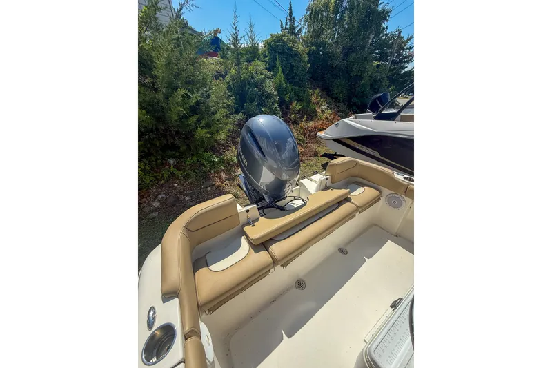 Slide: The Image of 2019 Key West 203 FS boat with Yamaha outboard motor, beige seating, and lush greenery background. - 7