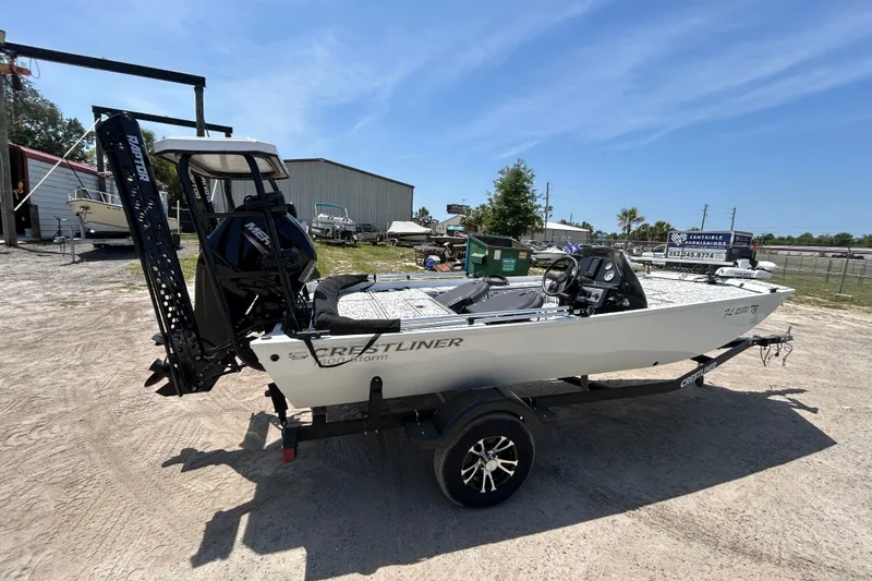 Slide: The Image of 2023 Crestliner 1600 Storm boat on trailer, parked outdoors under clear sky. - 3