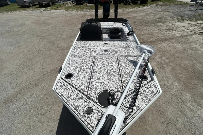 Slide: The Image of 2023 Crestliner 1600 Storm boat with camo deck, parked on gravel. - 5