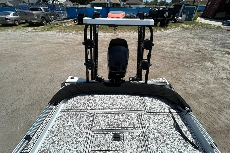 Slide: The Image of 2023 Crestliner 1600 Storm boat with camo deck and motor, parked outdoors. - 9