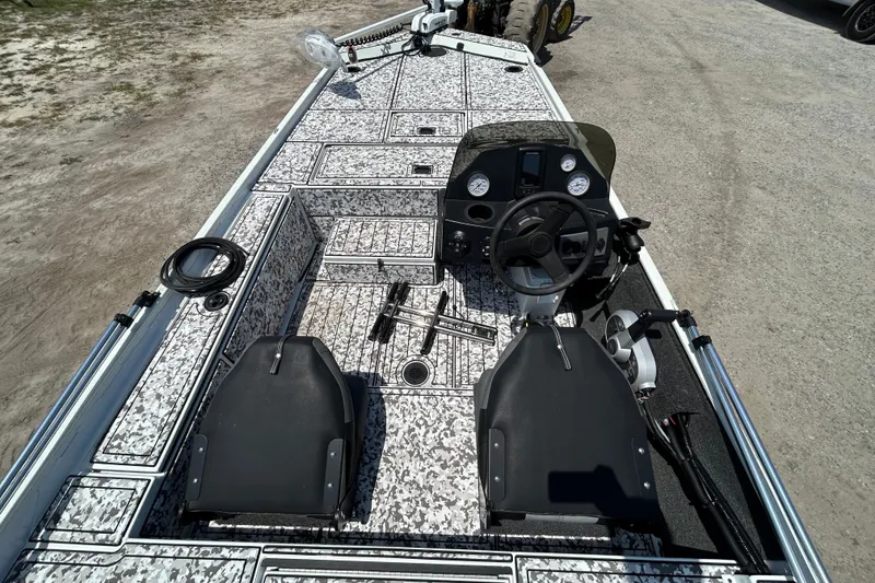 Slide: The Image of 2023 Crestliner 1600 Storm boat interior with steering console and patterned flooring. - 10