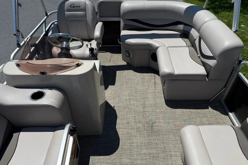 Slide: The Image of Luxurious 2018 Qwest 7516 SC pontoon boat interior with plush seating and steering console. - 8