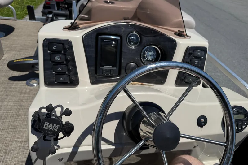 Slide: The Image of Steering console of 2018 Qwest 7516 SC boat with controls and gauges. - 5