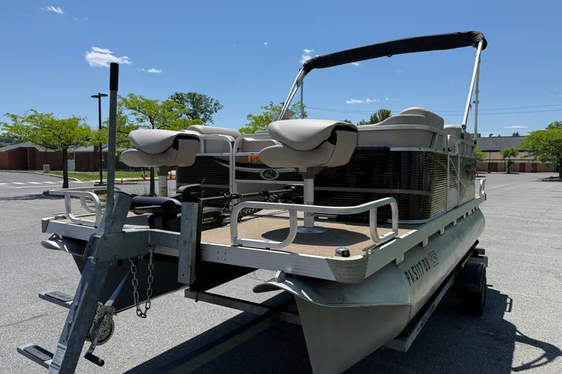 Slide: The Image of 2018 Qwest 7516 SC pontoon boat on trailer in sunny parking lot. - 2