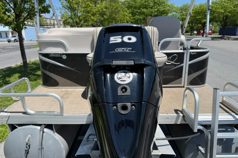 Slide: The Image of 2018 Qwest 7516 SC pontoon boat with 50 HP outboard motor, parked outdoors. - 3