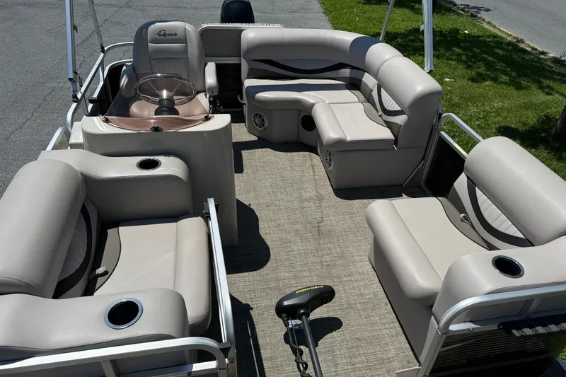 Slide: The Image of 2018 Qwest 7516 SC pontoon boat interior with beige seating and steering console. - 6