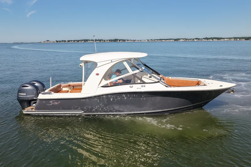 Slide: The Image of 2018 Scout 275 Dorado boat cruising on calm waters under a clear blue sky. - 6