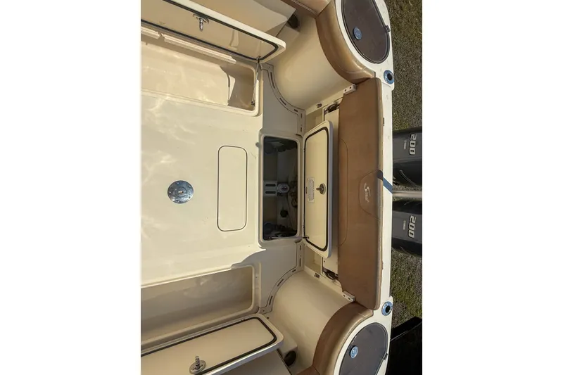 Slide: The Image of 2018 Scout 275 Dorado boat interior with storage compartments and seating. - 16
