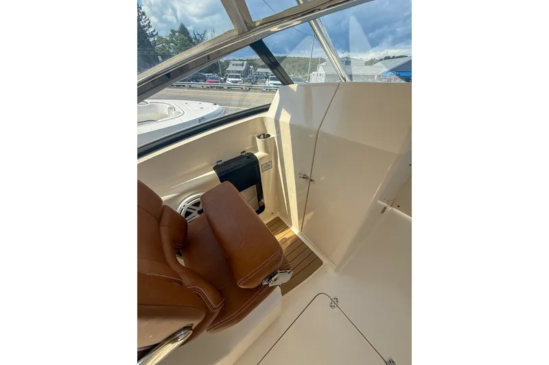 Slide: The Image of Interior view of 2018 Scout 275 Dorado boat with brown seating and sleek design. - 24