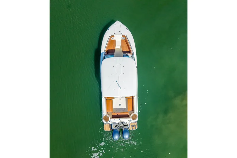 Slide: The Image of Aerial view of 2018 Scout 275 Dorado boat on green water. - 9