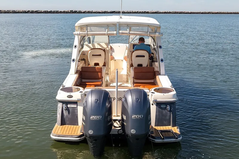 Slide: The Image of 2018 Scout 275 Dorado boat with dual Yamaha engines on calm water. - 4